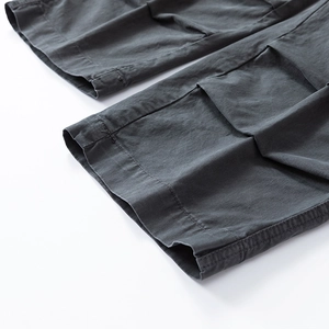 Detailed macro view of dark grey cotton cargo pants hem with double stitching craft