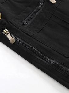 Close-up of bronze zipper and metal rivet on black cotton cargo pants fabric