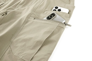Detail of khaki tactical pants featuring multi-pocket design and hidden zipper closure