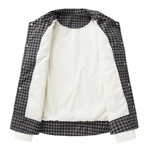 Detail of black and white plaid jacket showing layered collar and metal button closure