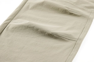 Close-up of khaki tactical pants showing durable ripstop fabric and reinforced double stitching