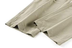 Close-up of khaki tactical pants hem featuring durable stitching and quick-dry fabric texture