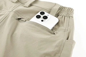 Detail of khaki tactical pants showing quick-dry fabric and secure rear zipper pocket