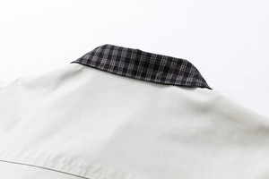 Detailed close-up of the jacket collar featuring premium plaid patchwork stitching