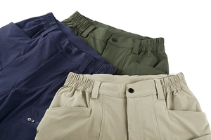 Detail of elastic waistbands and buckle closures on tactical outdoor trousers in three colors