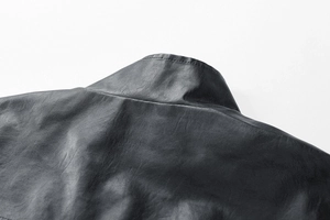 Close-up of black leather jacket stand collar with professional double stitching details