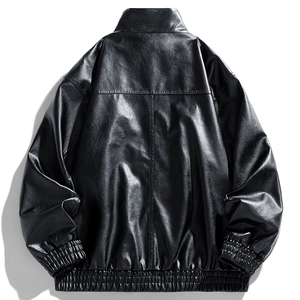 Detail view of black faux leather jacket showing back drop shoulder and elastic hem design