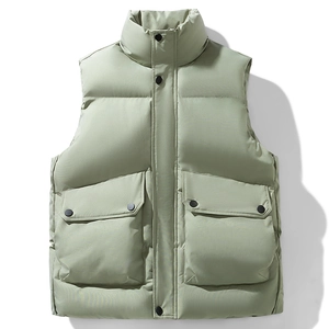 Dettaglio del gilet imbottito verde salvia con collo alto e grandi tasche a patta