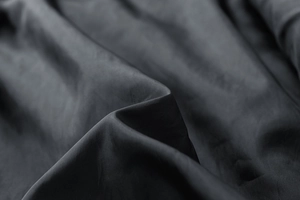 Macro detail of high-quality semi-matte black synthetic fabric texture for men's jackets