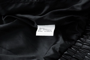 Detail view of the inner wash label showing PU leather and polyester fiber composition
