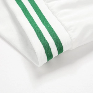 Detailed macro view of white elastic ribbed cuffs with two parallel green stripes