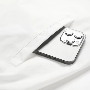 Close-up of side pocket on white baseball jacket showing depth with a smartphone inside