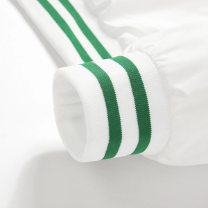 Close-up detail of white jacket sleeve with green striped ribbed knit cuffs