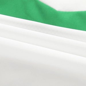 Macro detail of the green and white polyester fabric texture on a casual baseball jacket
