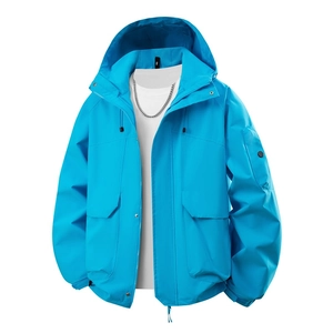Detail of bright blue outdoor jacket with functional utility pockets and velcro cuffs