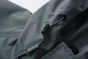 Detail of gray-blue outdoor jacket hood with adjustable drawstring and toggle closure