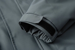 Detail of adjustable black velcro cuff on a blue-gray durable outdoor jacket