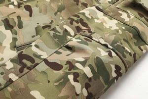 Detail of multicam tactical jacket showing high-performance ripstop fabric and reinforced seams