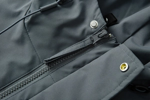 Close-up of functional outdoor jacket showing durable zipper and drawstring hood detail