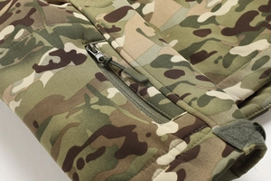Detail of camouflage tactical jacket featuring velcro cuffs and zipper with paracord puller