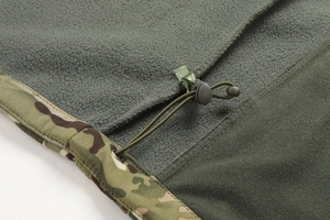 Detailed view of camouflage jacket hem with green fleece lining and adjustable drawstring cord