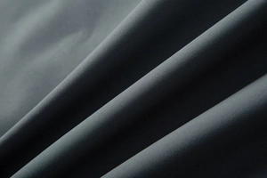 Close-up of high-density dark grey fabric texture showing windproof and durable weaving