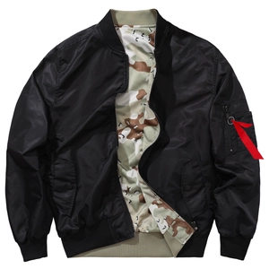 Detail view of black bomber jacket with camo lining and iconic red ribbon on sleeve pocket