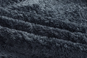 Macro trama di spesso tessuto pile grigio scuro che mostra calore e materiale morbido