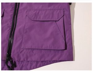 Detail of cargo pocket and black resin zipper on purple functional outdoor jacket