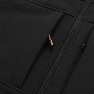 Detail van winddichte stof en functionele zak met oranje trekkoord op zwarte jas