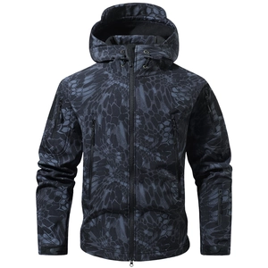 Detail of tactical camo jacket featuring adjustable velcro cuffs and utility arm pockets