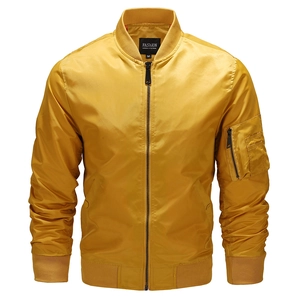 Detail of a bright yellow bomber jacket showing the metallic zipper and sleeve pocket