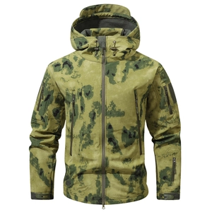 Detail of green camouflage tactical jacket showing waterproof fabric and multiple pockets