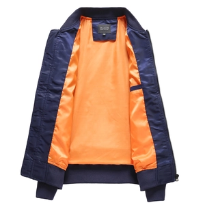 Detail of navy bomber jacket featuring contrast orange lining and ribbed knit collar