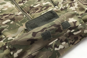 Detailed macro shot of the camo tactical jacket featuring durable velcro and zipper parts