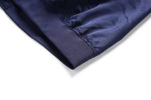 Detailed macro view showing the ribbed cuffs and high-quality weave of this navy blue jacket