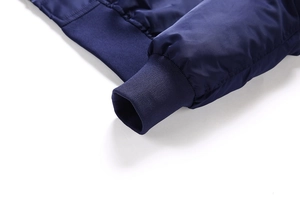 Detailed macro view of dark blue bomber jacket elastic ribbed cuffs and stitching