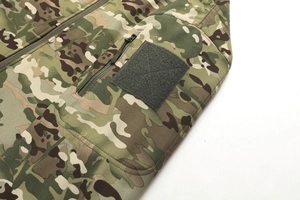Detail view of camouflage tactical jacket with high-quality zipper and velcro patch area