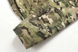 Detail view of Multicam tactical jacket sleeve with zipper pocket and velcro cuff adjustment