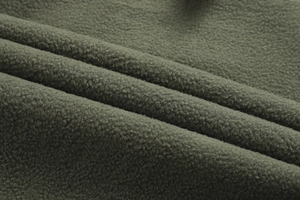 Close-up of military green thermal fleece lining for windproof softshell jacket
