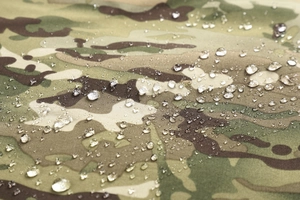 Macro shot of water droplets on waterproof multicam fabric of the outdoor jacket