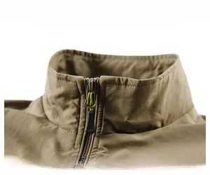 Close-up of khaki outdoor vest showing stand collar, zipper detail and windproof fabric