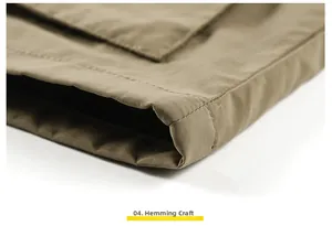 Close-up of the double-stitched hem on a khaki outdoor vest showing durable fabric detail