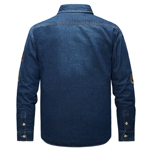 Vista posteriore di una camicia di jeans blu scuro con toppe ricamate in stile vintage