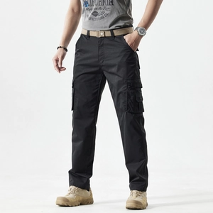 Close-up of black cargo pants with side flap pockets and a khaki canvas belt