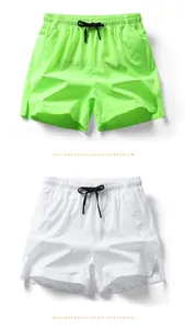 Close-up of quick-dry shorts featuring elastic waistbands, drawstrings, and side slits details