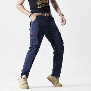 Detailed close-up of side cargo pocket with red fashion embroidery on navy blue pants