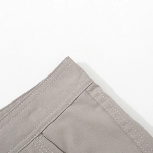 Detailed close-up of premium stitching on grey multi-pocket straight casual cargo pants