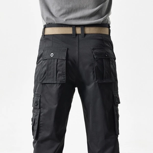 Detail view of black cargo pants featuring multi-pockets and a khaki canvas belt
