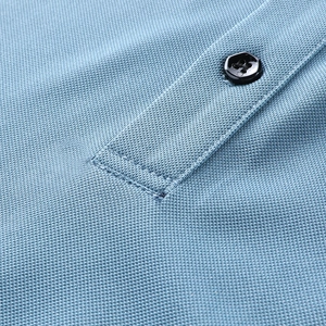 Detailed macro view of light blue polo shirt pique fabric texture and black button detail